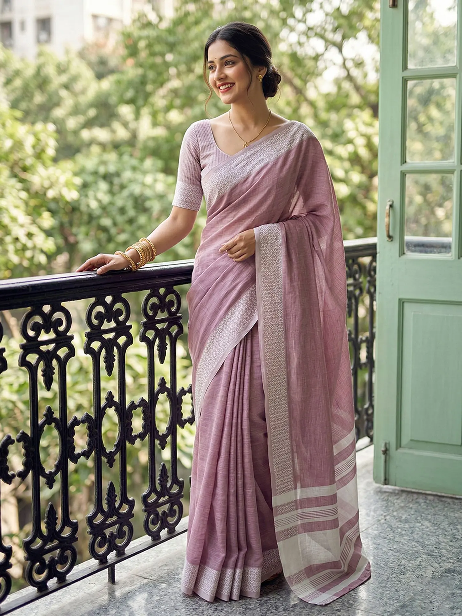 Woman posing gracefully in a traditional saree outdoors
