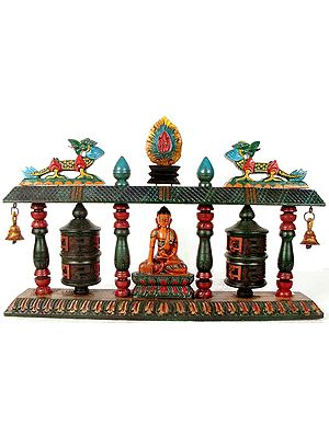 The Buddha Flanked by Prayer Wheels