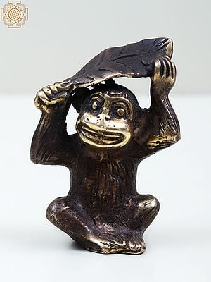 Small Brass Monkey Holding a Leaf Over Its Head