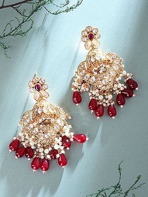 Kundan Jhumka Earrings with Floral Accents and Red Gemstone Drops