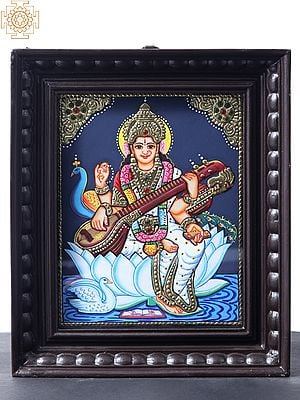 Four Armed Goddess Saraswati Seated on White Lotus | Tanjore Painting | With Teakwood Frame