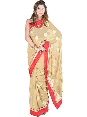 Curry-Mustard Saree with All-Over Embroidered Leaves and Red Patch Border