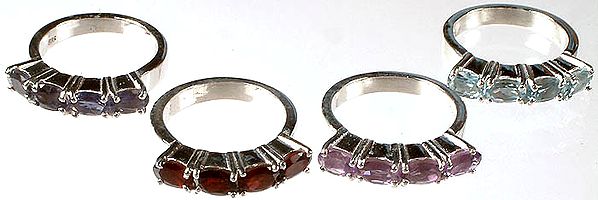Lot of Four Faceted Gemstone Rings<br>(Iolite, Garnet, Amethyst & Blue Topaz)