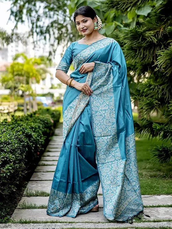 Designer Raw Silk Saree With Floral Motifs Woven Border And Attractive Tassels Pallu