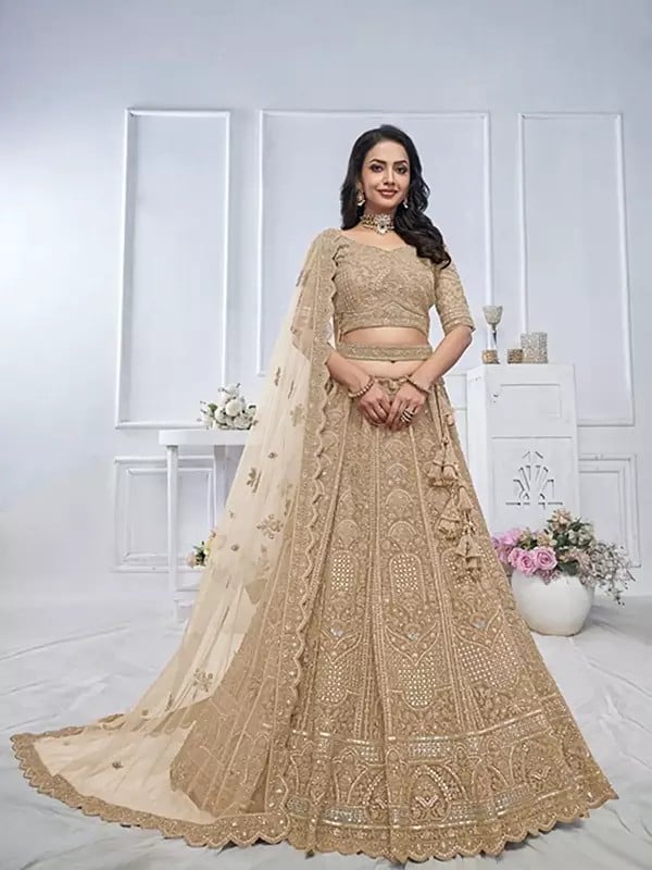 Soft Net Heavy Embroidered Bridal Lehenga Choli With Tassels And Matching Dupatta